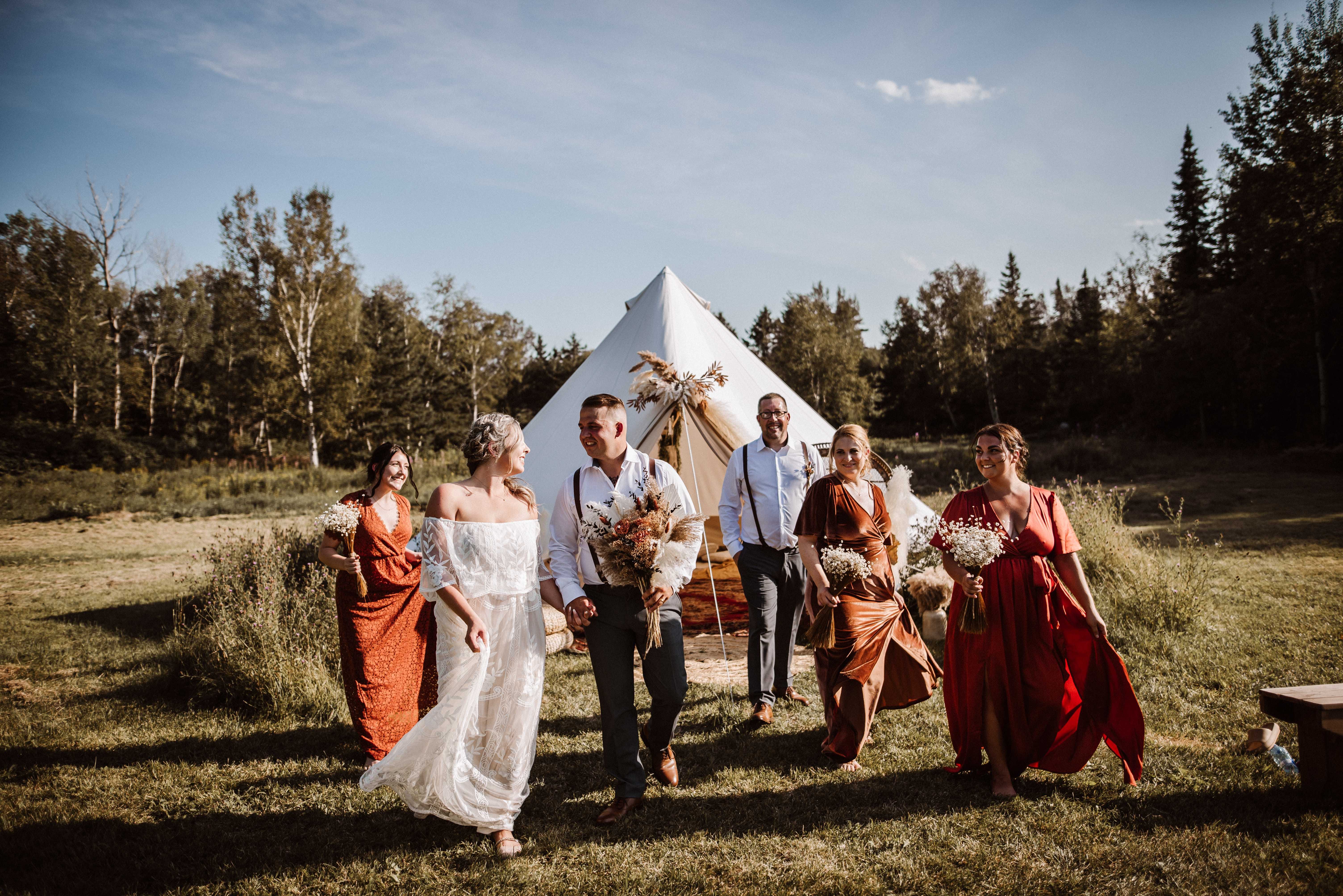 Wedding with bribe and groom in front of a sibley canvas tent Wedding with bribe and groom in front of a sibley canvas tent