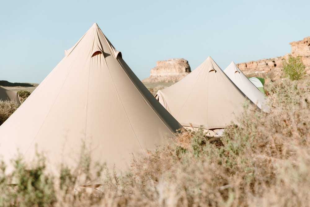 multiple sibley canvas tents in the grasslands multiple sibley canvas tents in the grasslands