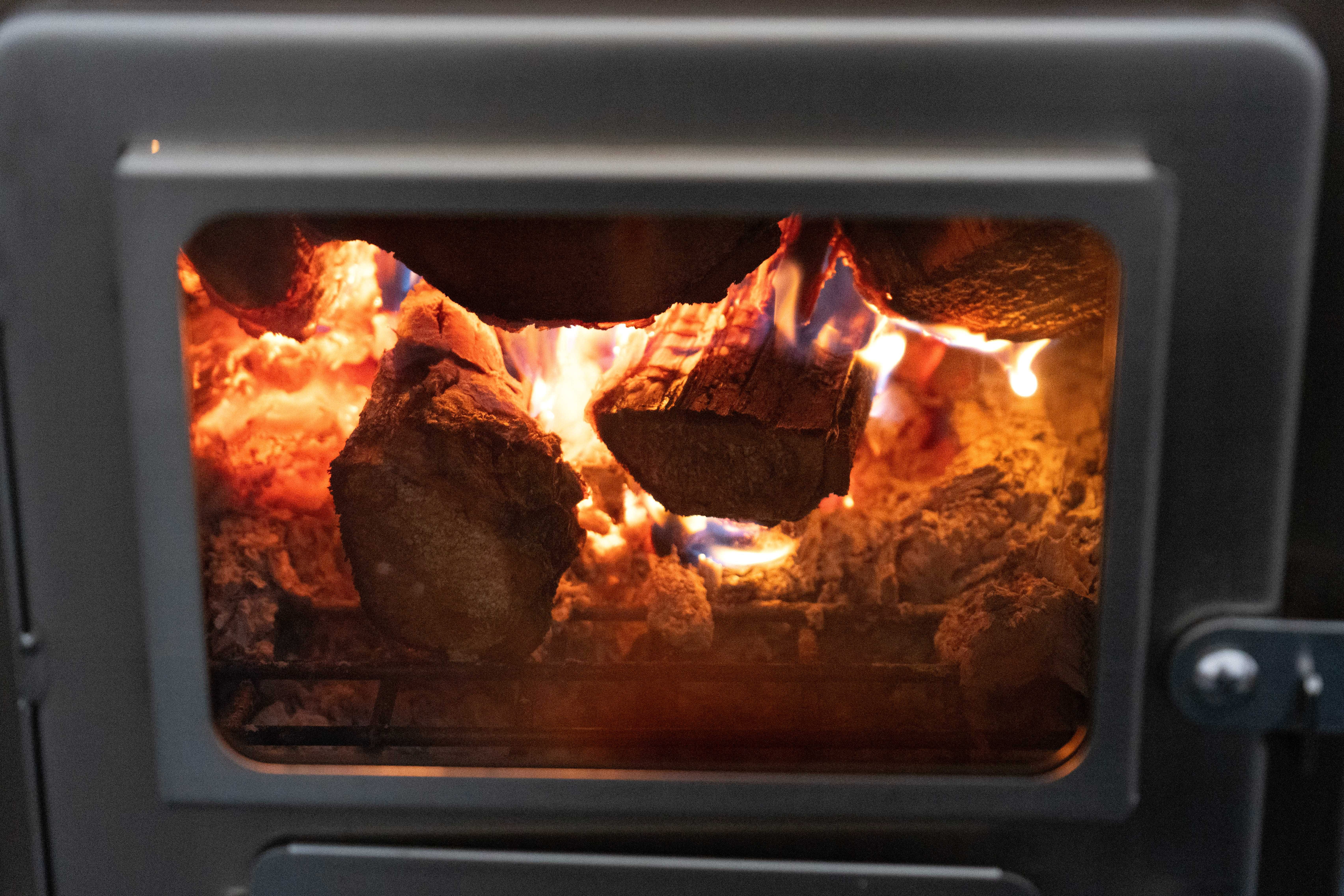 Watching wood burn through glass of a tent stove Watching wood burn through glass of a tent stove